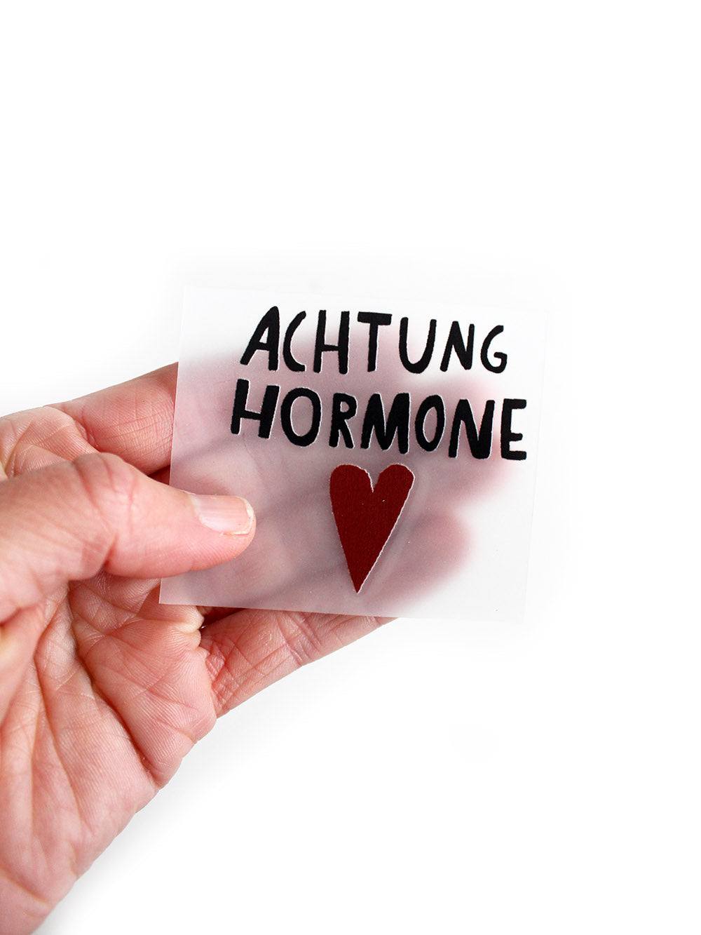 bügelbild randlos achtung hormone von halfbird von hand gehalten