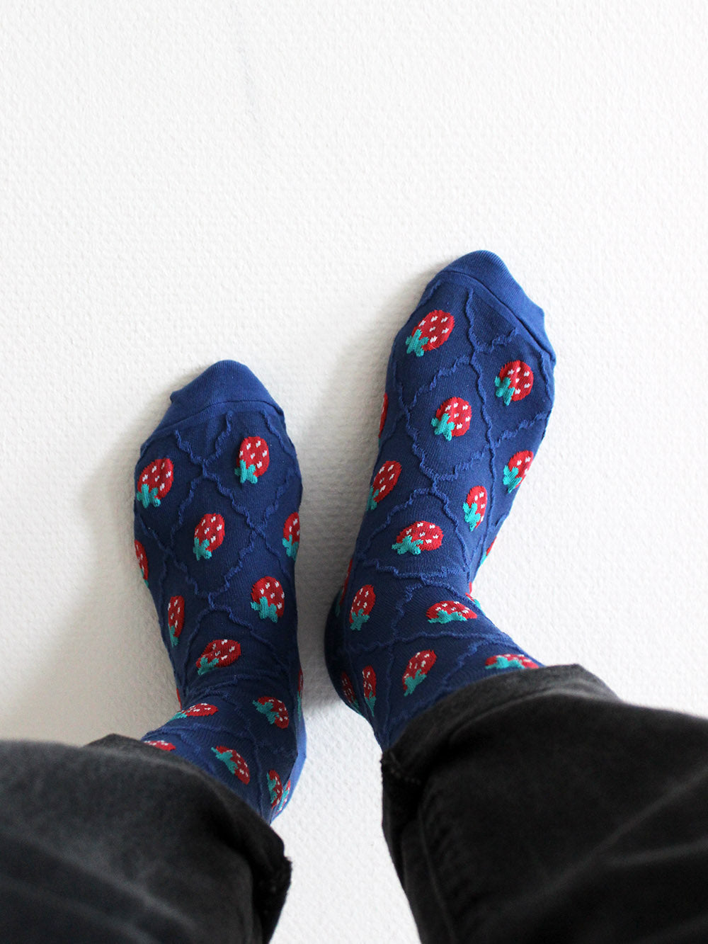 Tragebild blaue Socken mit Erdbeeren mit schwarzen Jeans